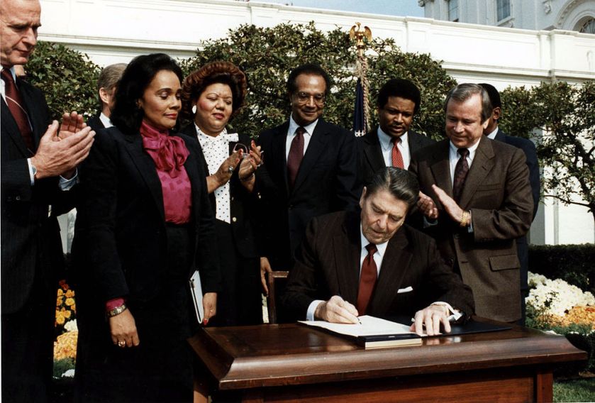 1024px-reagan_signs_martin_luther_king_bill
